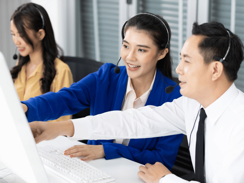People pointing at computer